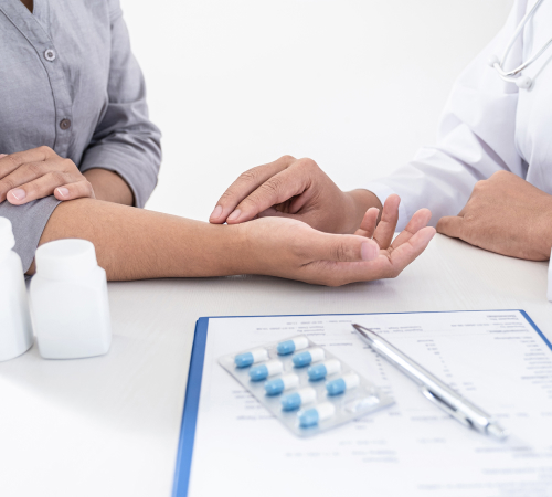 A picture of a doctor checking his patient's pulse.