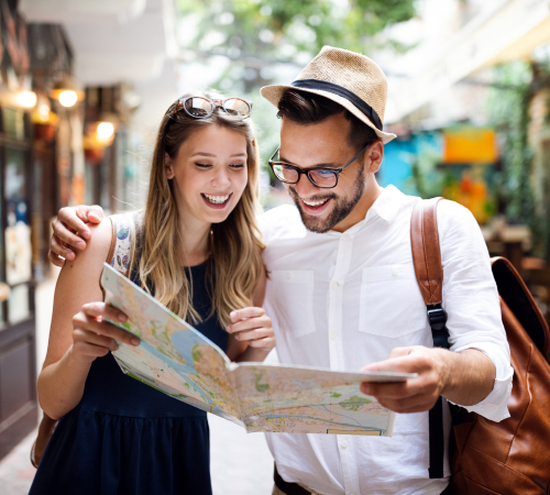 An image shows a man and a woman holding and watching a map.