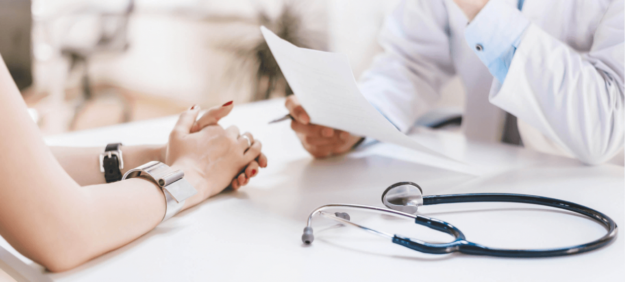 An Image of a doctor conducting routine diabetes health checkups, explaining to the patient, with a stethoscope placed on a table.