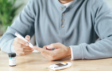 In this picture, a person is seen checking their diabetes using a diabetes monitoring machine.