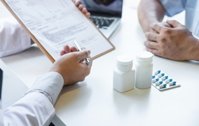 A picture of a doctor describing a prescription of medicine to the patient.