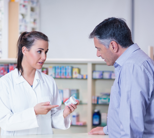 A picture of a doctor describing a medicine to the patient.