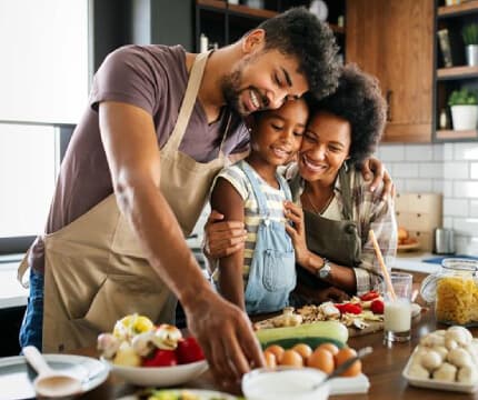 A family preparing food in a kitchen together