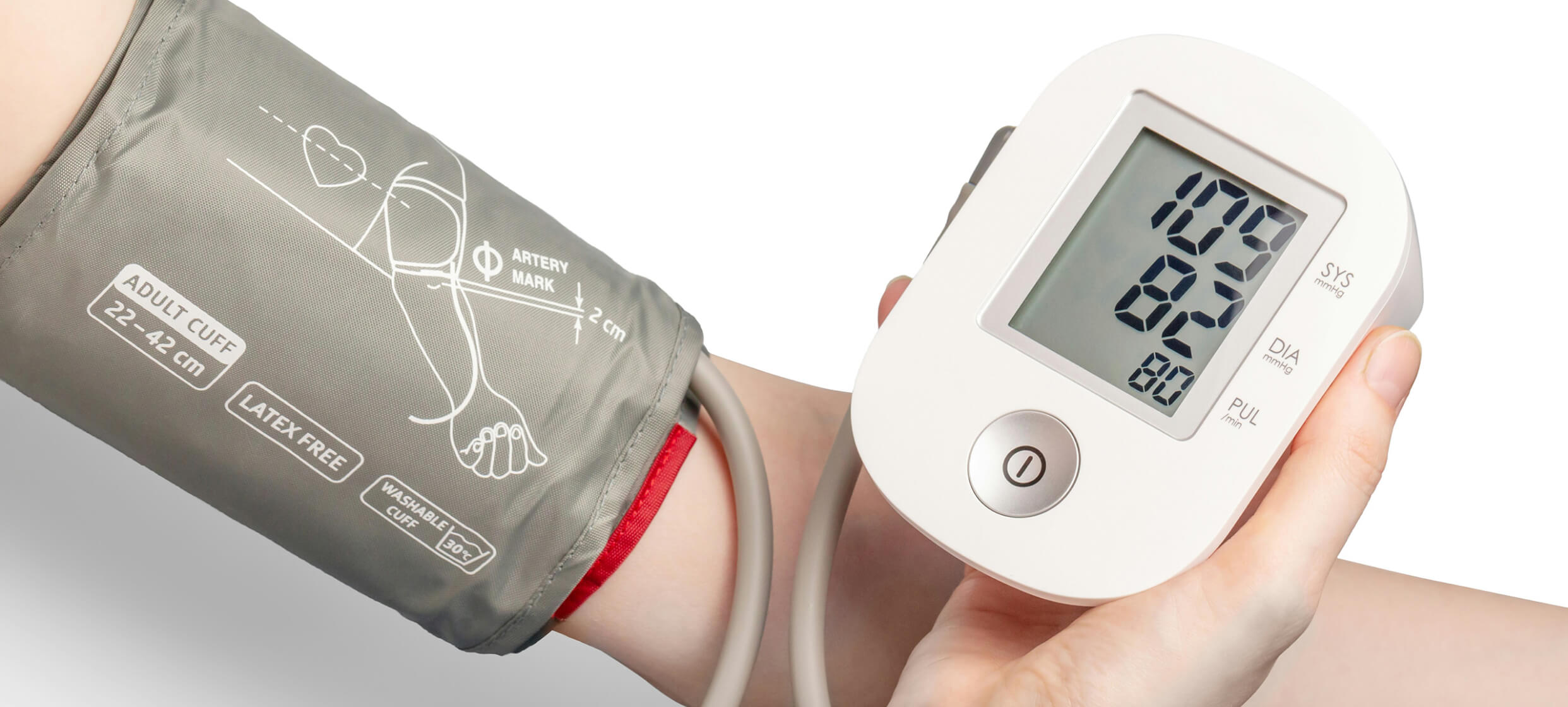 Blood pressure device wrapped around arm with digital monitor in other hand