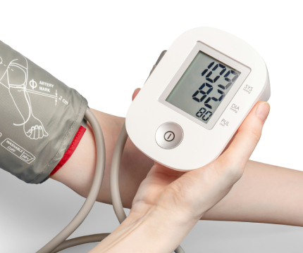 Blood pressure device wrapped around arm with digital monitor in other hand